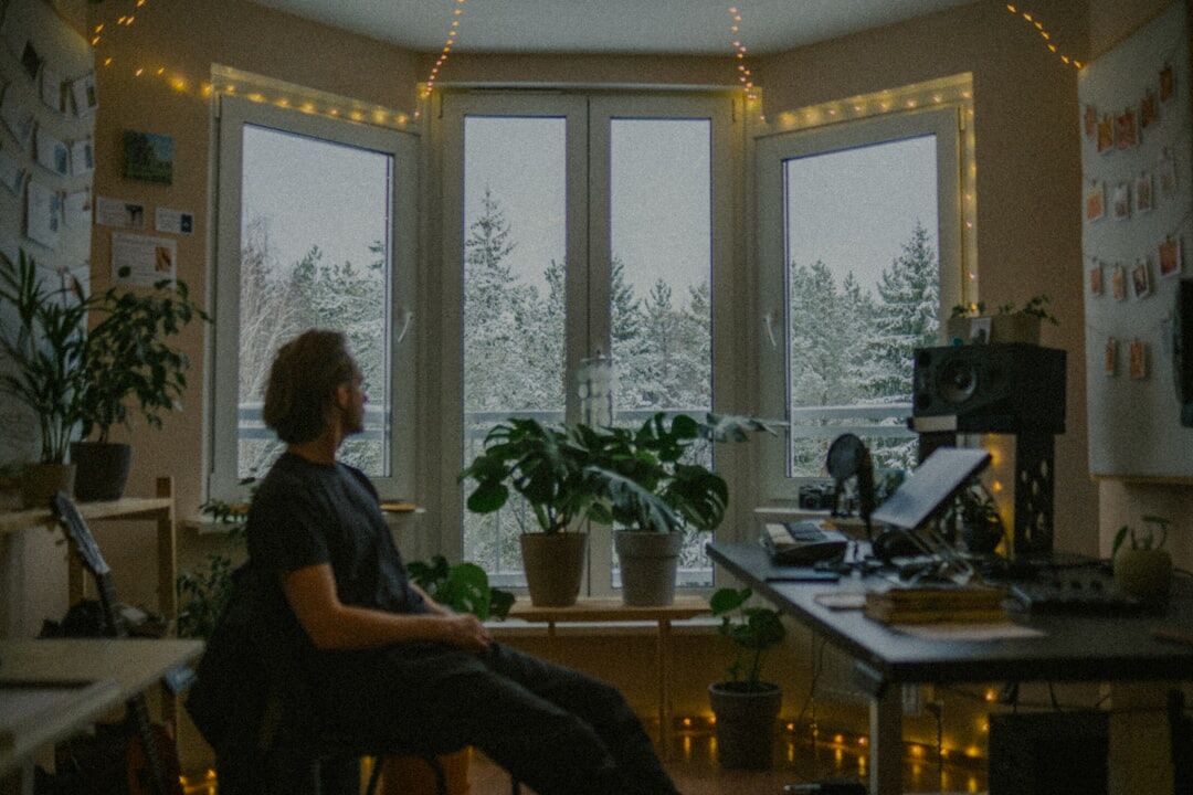Person writing notes in a bright home office