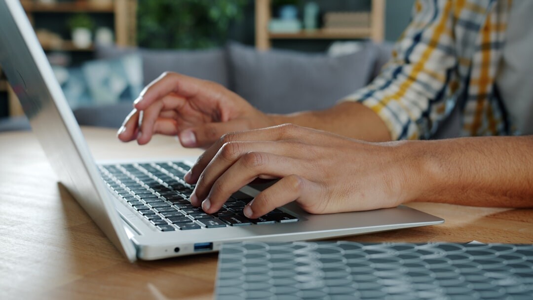 person writing on laptop