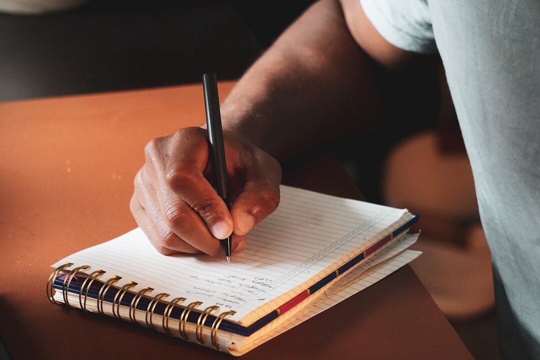 person writing in journal