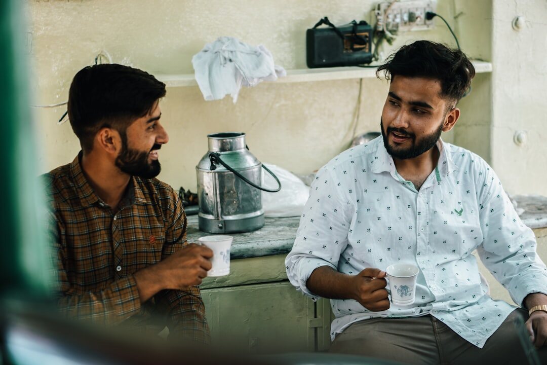 Two people having a friendly conversation over coffee
