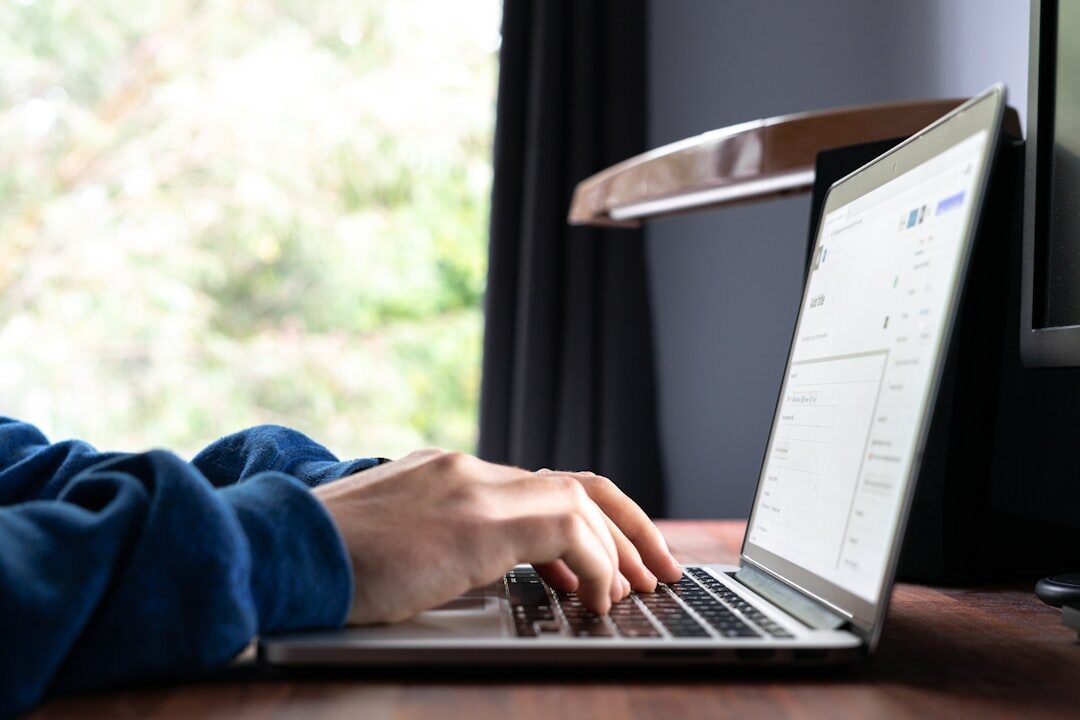 person writing on laptop